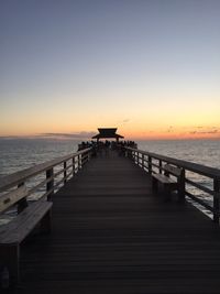 Pier over sea against clear sky