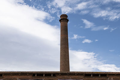 Low angle view of smoke stack against sky