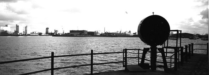 Silhouette of harbor with city in background