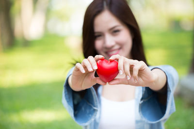Portrait of a smiling young woman holding ice cream