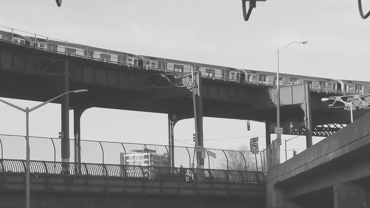 built structure, architecture, railing, building exterior, text, building, bridge - man made structure, western script, transportation, day, railroad station, city, indoors, connection, graffiti, railroad station platform, window, clear sky, wall - building feature