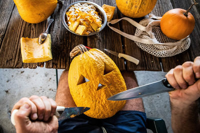 Cropped hand of person preparing food on table