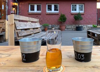 Beer glass on table against building