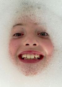 Close-up child's face in bubble bath