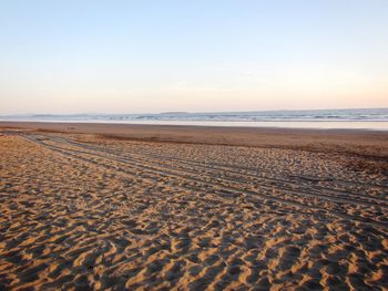 Scenic view of beach against clear sky