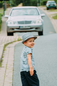 Portrait of boy standing on road