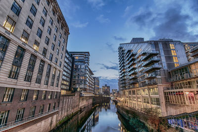 Canal amidst buildings in manchester, united kingdom