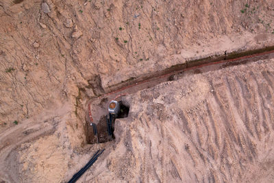 High angle view of worker working on rock