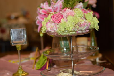 Close-up of rose in glass vase on table