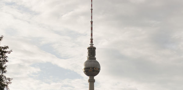 Low angle view of communications tower against sky