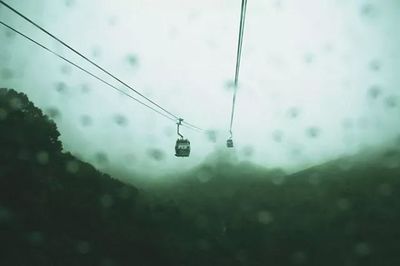 Low angle view of power lines against sky