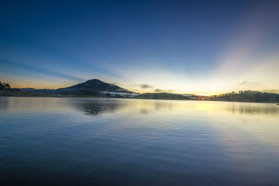 Scenic view of lake against sky during sunset