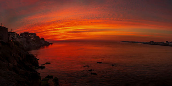 Scenic view of sea against orange sky