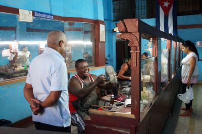 People working at market stall