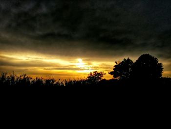 Silhouette of landscape against cloudy sky