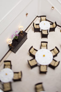 Tilt-shift image of tables and chairs arranged in restaurant