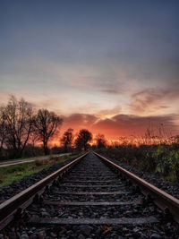 Train tracks as leading lines into a burning sky during a beautiful sunrise in northern germany