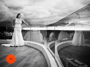 Rear view of woman against cloudy sky