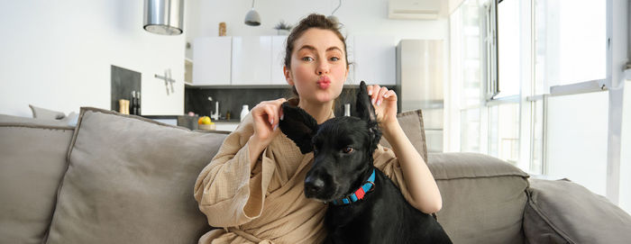 Portrait of young woman with dog