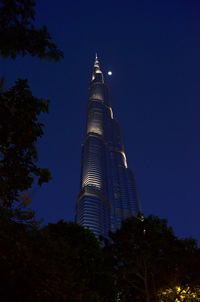 Low angle view of skyscrapers lit up at night