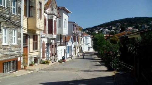 Houses in town against clear sky