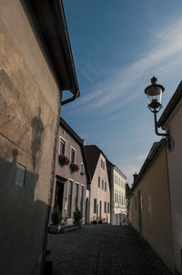 Street amidst buildings against sky