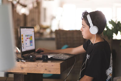 Boy doing his homework on laptop