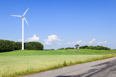 Windmill on field against sky