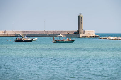 Nautical vessel on sea against clear sky