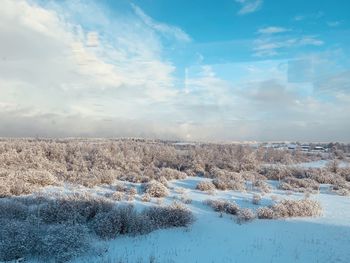 Scenic view of snow covered landscape against sky
