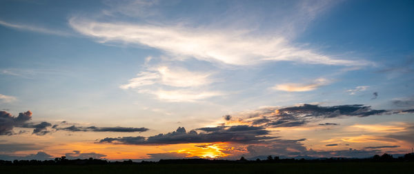 Low angle view of silhouette field against sky during sunset