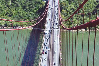 Vehicles on bridge road over the lake