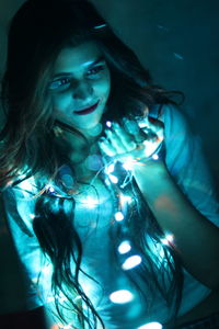 Portrait of woman with illuminated hair