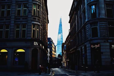 View of city street and buildings against sky