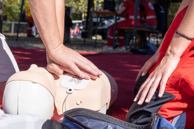 Hands of a paramedic doing chest compression during defibrillator cpr training