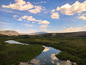 Scenic view of lake against cloudy sky