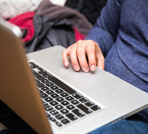 Midsection of man using mobile phone