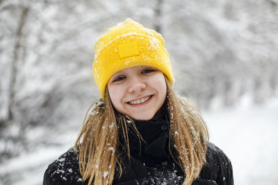 Portrait of young woman wearing warm clothing standing outdoors