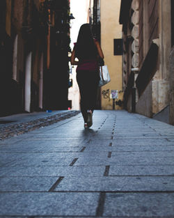 Surface level shot of woman walking on street