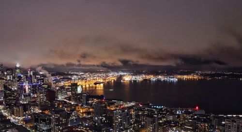 High angle view of city lit up at night