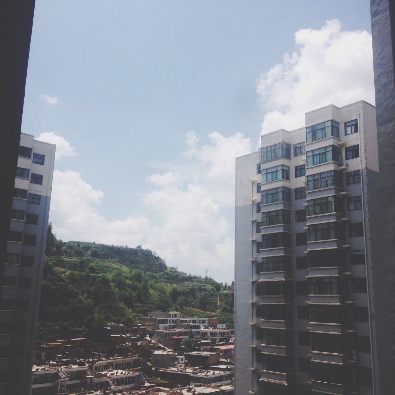 building exterior, architecture, built structure, sky, city, cloud - sky, residential building, residential structure, cloud, building, tree, residential district, cityscape, day, low angle view, house, outdoors, modern, cloudy, no people