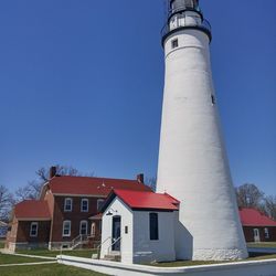 Low angle view of lighthouse against clear blue sky