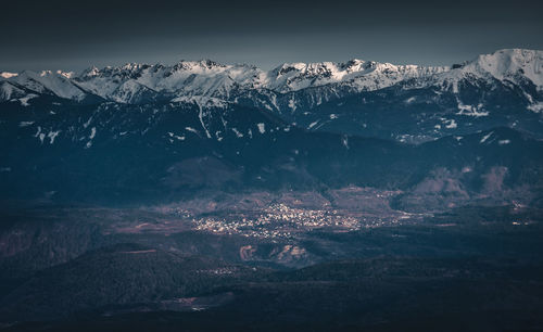 Aerial view of snowcapped mountains against sky at night