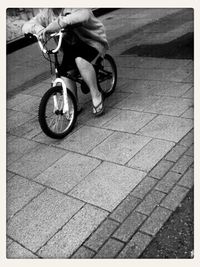 Low section of woman standing on tiled floor