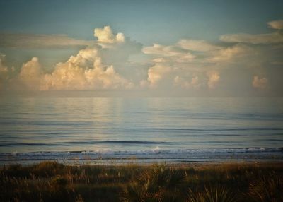 Scenic view of sea against cloudy sky