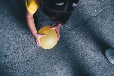 High angle view of woman holding ball at home