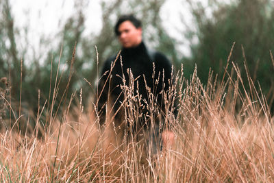 Young man in a forest wheat field
