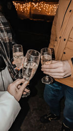 Midsection of man holding wineglass