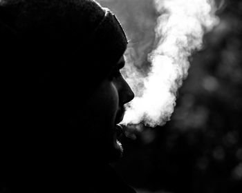 Close-up portrait of man smoking cigarette