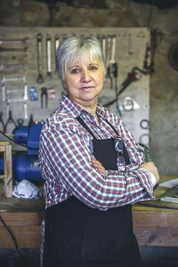 Portrait of woman standing against wall